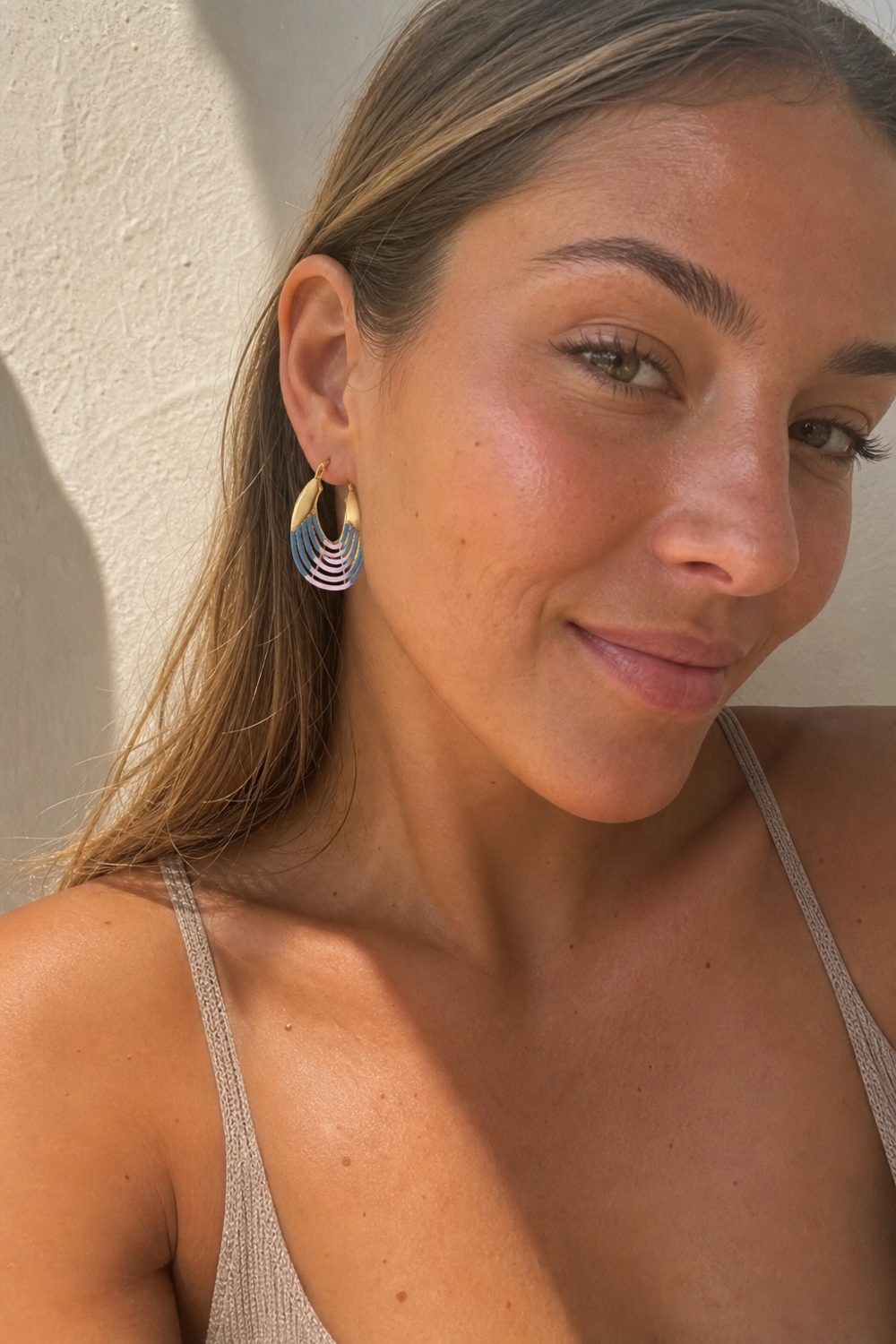 Customer wearing Sunrise Ripple Hoops