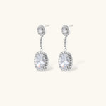 Elegant white gold plated jewelry set with oval cubic zirconia stones in halo settings, featuring Y-necklace and drop earrings.