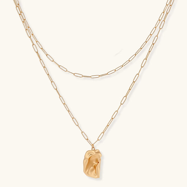 Layered paperclip chain necklace with organic flowing pendant made from eco-zinc alloy in warm gold finish