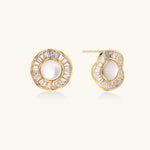 Gold-plated stud earrings with central freshwater pearl surrounded by radiating baguette crystals in sunburst design