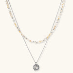 Complete jewelry set featuring citrine stone chips, silver beads, and cosmic circle pendants on cream background.