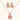 Ornate gold-plated jewelry set with rose pink zirconia center stones and crystal accents on cream background.