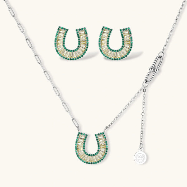 Geometric horseshoe-shaped jewelry set with radiating white zirconia center and jade-green border stones on white background.