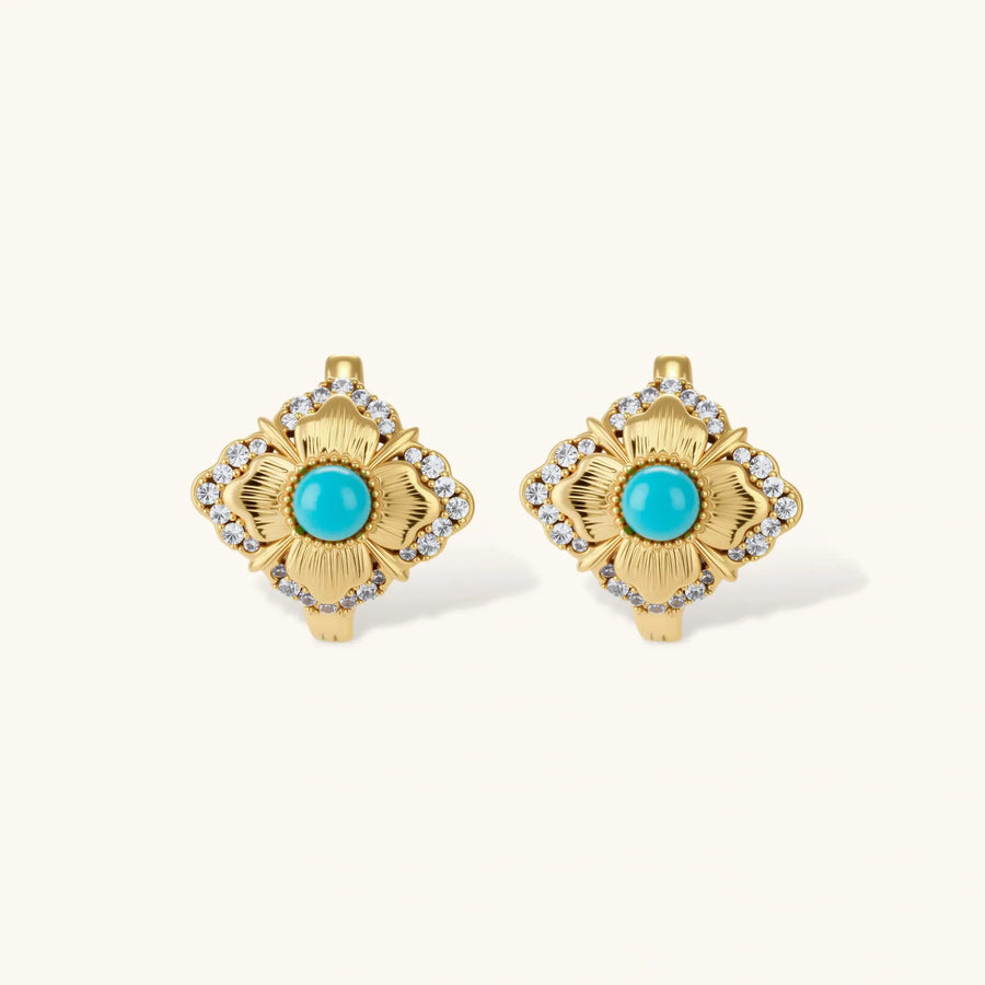 Close-up of 18K gold plated hoop earrings with turquoise center stones and zircon crystals in quatrefoil flower design