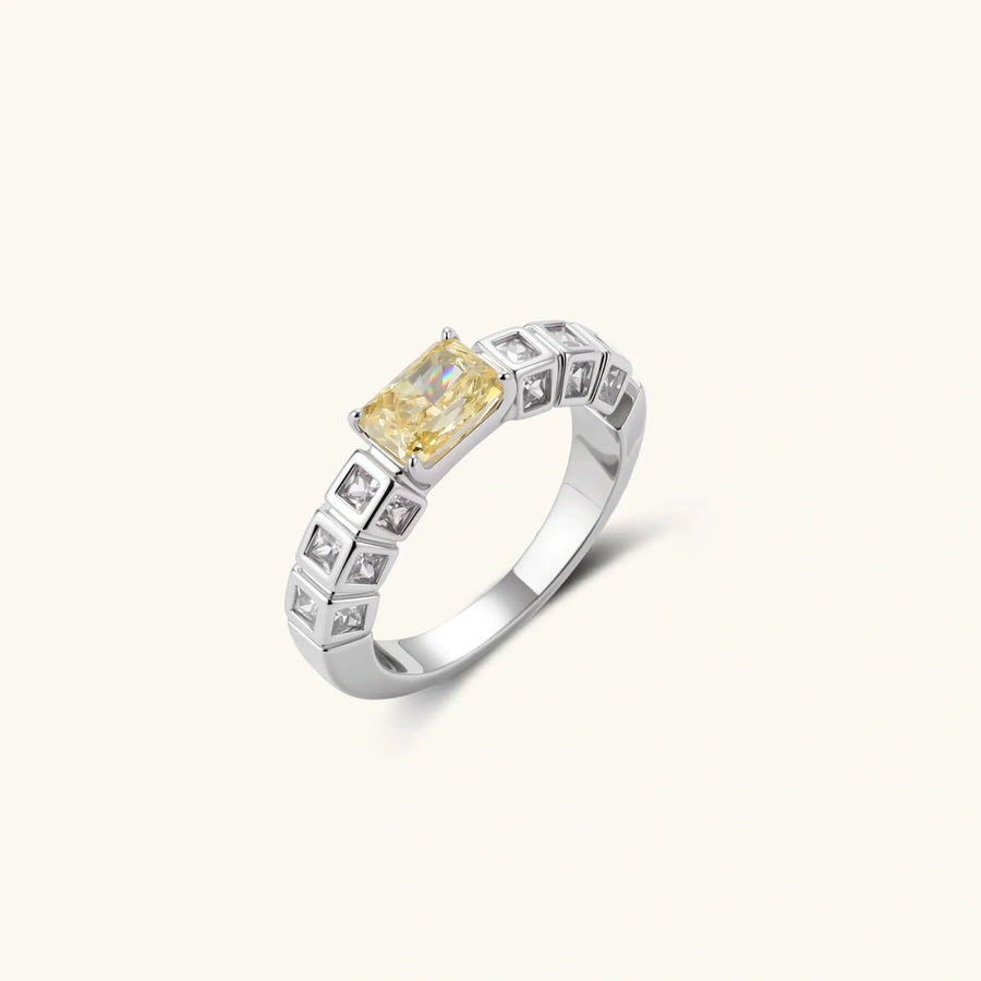 Adjustable ring with emerald-cut yellow zirconia center and clear accent stones in geometric platinum-plated setting