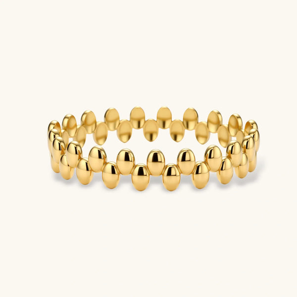 18K gold plated stainless steel bangle with dual rows of polished oval pebble beads on a cream background.